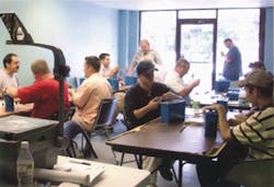 Photo 1. Students knuckle down to practice key impressioning procedures. Photo 1. Students knuckle down to practice key impressioning procedures.