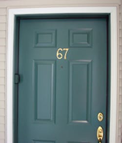 Residential wood front door with wood frame.