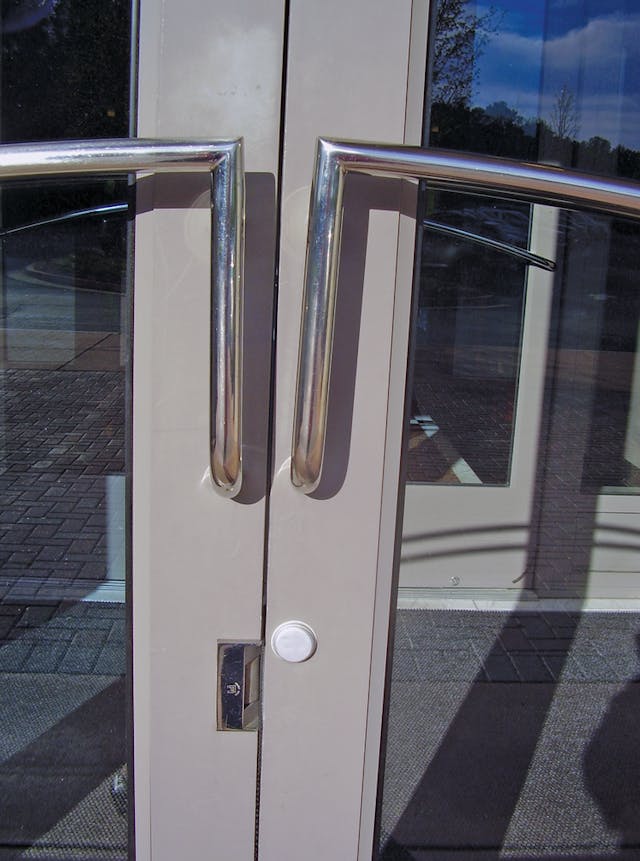 Fire-rated office building doors. (We do not endorse this method of disabling the keyed lock cylinder)