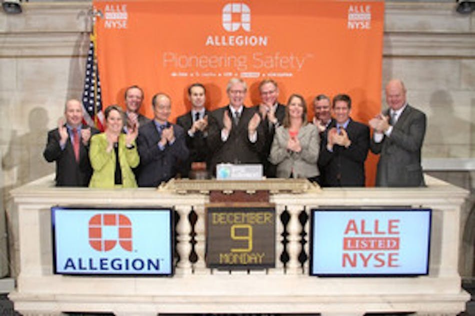 Allegion Chariman, President and CEO Dave Petratis (center) rings the opening bell at the New York Stock Exchange on Monday with other company executives.