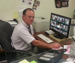 School principal Josh Youel checks surveillance footage