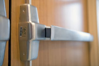 Panic hardware or fire exit hardware is required for some egress doors, based on occupancy classification and occupant load. No other mechanical security device may be installed on a door with panic hardware.