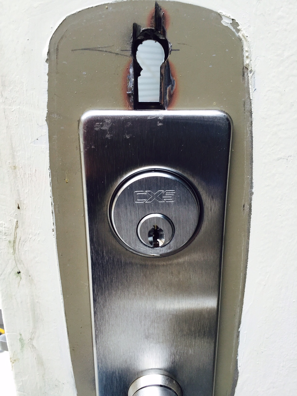 Photo 1. Electronic locks had required a secondary hole to run wires from the exterior to the interior of the doors