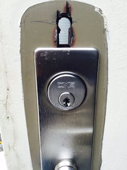 Photo 1. Electronic locks had required a secondary hole to run wires from the exterior to the interior of the doors Photo 1. Electronic locks had required a secondary hole to run wires from the exterior to the interior of the doors