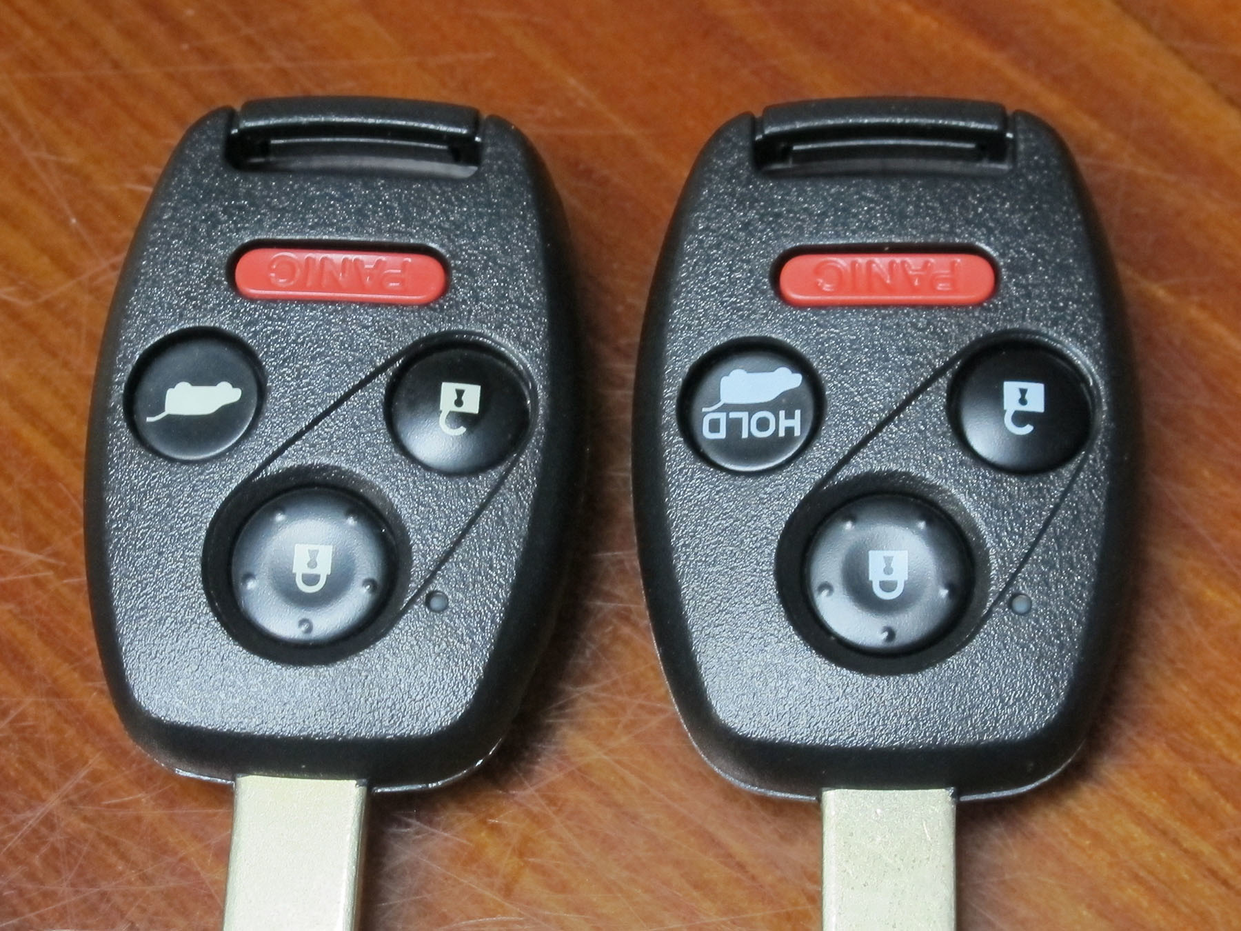 Photo 1. Photo-1: Two nearly identical Honda Pilot IRKs. The key on the left releases the rear glass in the hatch, while the key on the right operates the power opening and closing of the entire hatch.