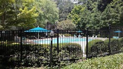 Photos 1-3. This homeowners association pool got new code-compliant fencing. However, the gate is so damaged and misaligned that it does not lock. The solution was a mag lock at the top of the gate, a fob reader, and a pedestal mounted inside the pool area with a request-to-exit button. They previously installed extra grating on and around the gate to prevent folks from reaching in. Photos 1-3. This homeowners association pool got new code-compliant fencing. However, the gate is so damaged and misaligned that it does not lock. The solution was a mag lock at the top of the gate, a fob reader, and a pedestal mounted inside the pool area with a request-to-exit button. They previously installed extra grating on and around the gate to prevent folks from reaching in.