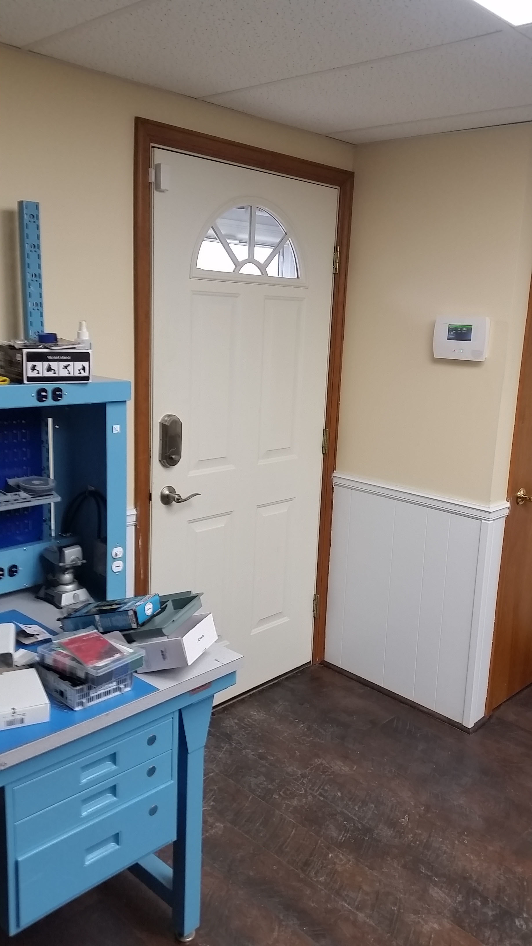This picture says it all from a wireless standpoint. Here you have a wireless transmitter atop the door, a wireless electronic lock, and the alarm system keypad that controls the wireless sensors.