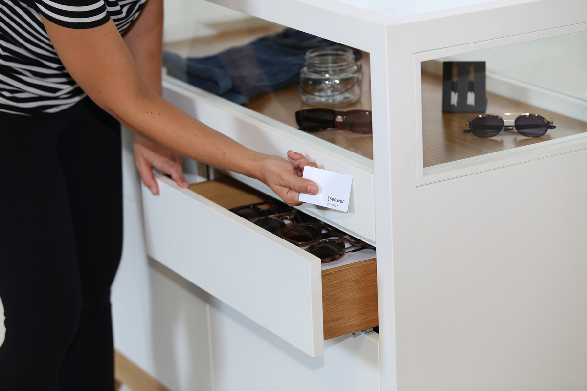 Opening drawer below retail display with card