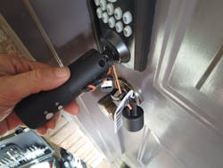 The LockTech SmartKey Decoder is inserted into a Kwikset SmartKey lock before decoding.