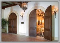 A floor door closer that has offset pivots is the only way to properly hang and control decorative arched-top doors such as these.