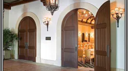 A floor door closer that has offset pivots is the only way to properly hang and control decorative arched-top doors such as these.