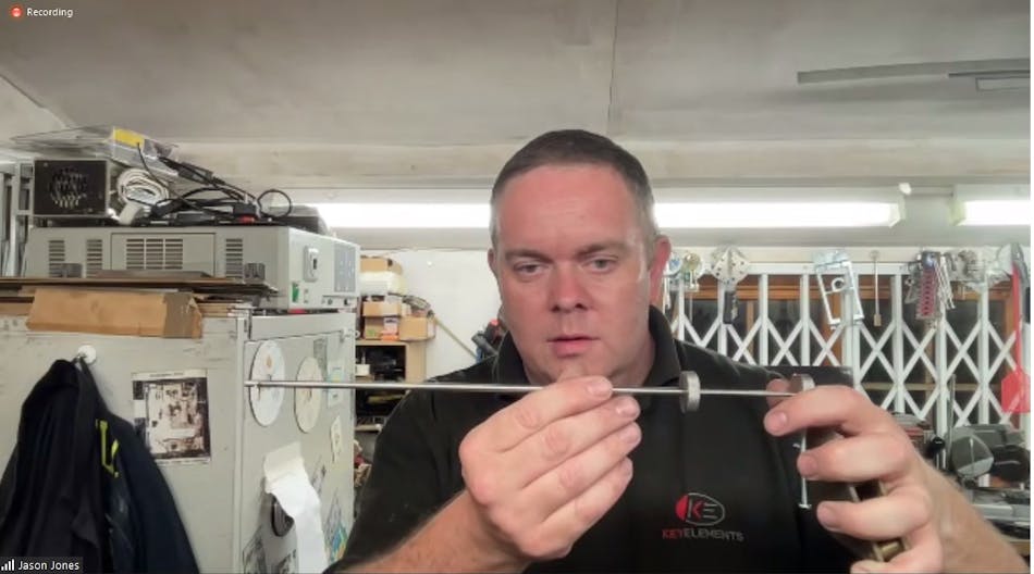 Jason Jones displays one of his lever-lock picks. He applies tension via the lever on the right, while the dial controls the tapping. Jason Jones displays one of his lever-lock picks. He applies tension via the lever on the right, while the dial controls the tapping.