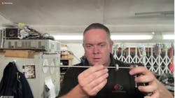 Jason Jones displays one of his lever-lock picks. He applies tension via the lever on the right, while the dial controls the tapping. Jason Jones displays one of his lever-lock picks. He applies tension via the lever on the right, while the dial controls the tapping.