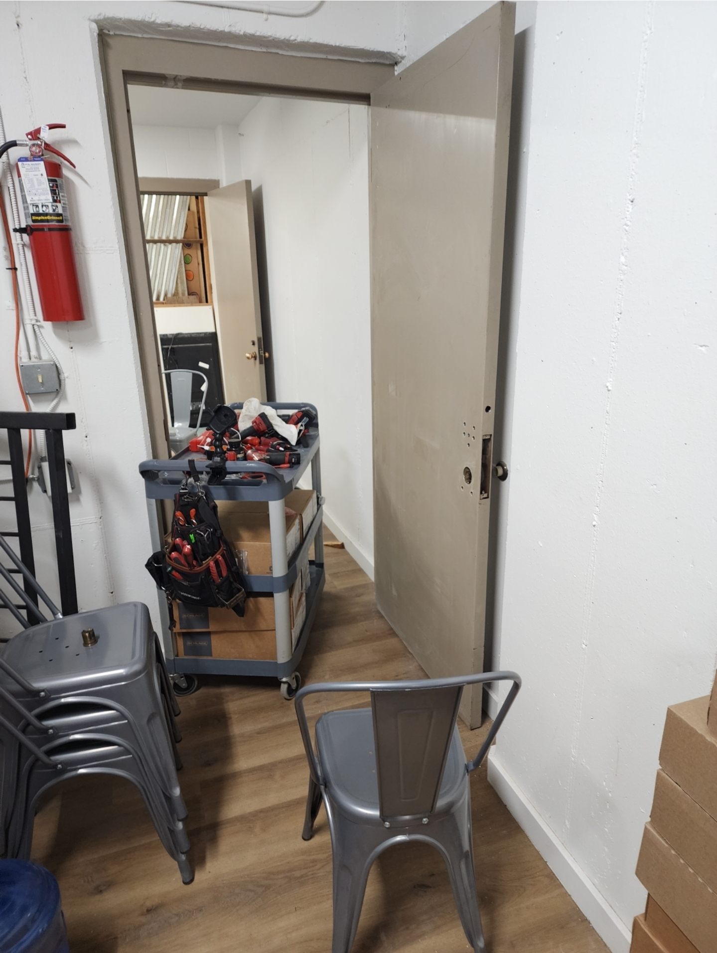 Photo 1. Metal door ready for installation, tools on cart.