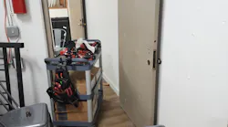 Photo 1. Metal door ready for installation, tools on cart.