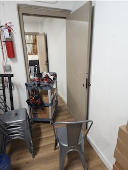 Photo 1. Metal door ready for installation, tools on cart. Photo 1. Metal door ready for installation, tools on cart.