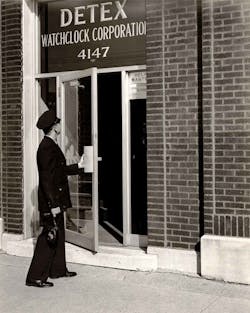 A guard outside the original Detex Watchlock Corp. building in Chicago