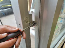 Photo 2. Removing screws from middle pivot hinge Photo 2. Removing screws from middle pivot hinge