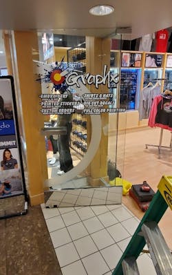 Photo 1. Herculite door with broken lock mechanism Photo 1. Herculite door with broken lock mechanism