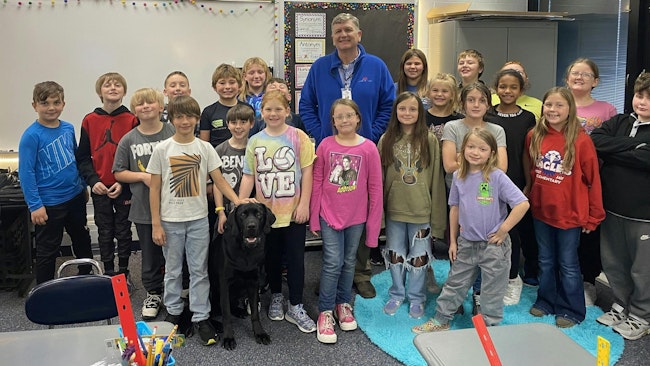 Jay County School Superintendent Jeremy Gulley and the district's weapon's detecting dog, a Black Labrador named Jack, at one of the five elementary schools in the district,